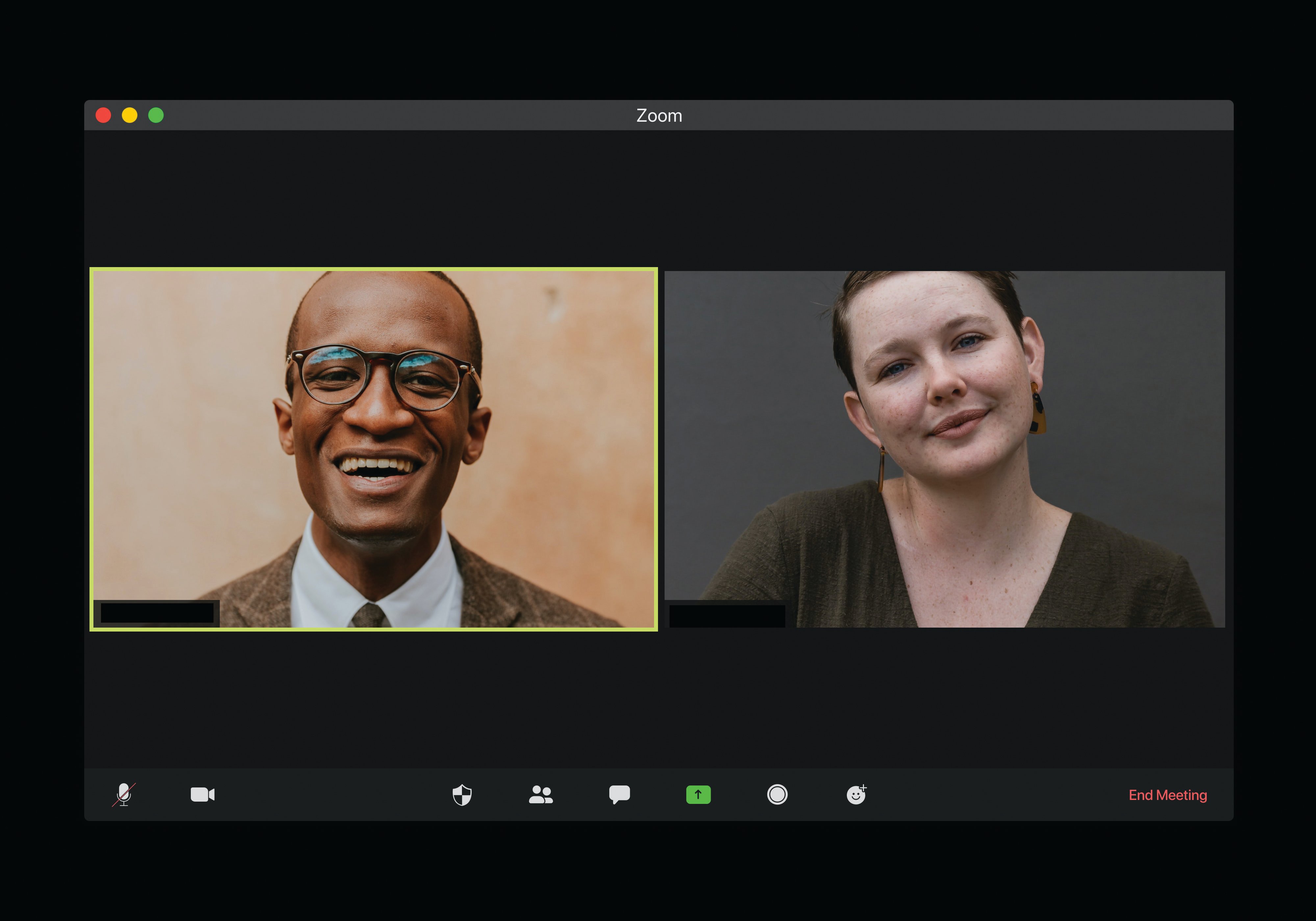 A Zoom call featuring two people. The person on the left is wearing glasses and a suit. The person on the right is wearing a dark top.